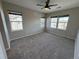 Spacious bedroom with plush carpet, ceiling fan, and plenty of natural light from three windows at 13013 Grant Cir # C, Thornton, CO 80241