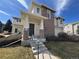 Beautiful home exterior with brick accents, a covered entryway, and manicured landscaping at 13013 Grant Cir # C, Thornton, CO 80241