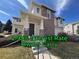 Inviting home exterior with a brick facade, covered porch, and well-manicured lawn under a bright blue sky at 13013 Grant Cir # C, Thornton, CO 80241