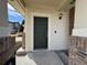 Inviting home entrance featuring a dark green front door and charming exterior details with a small porch at 13013 Grant Cir # C, Thornton, CO 80241