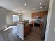 Modern kitchen with a center island, stainless steel appliances, and wood cabinets at 13013 Grant Cir # C, Thornton, CO 80241