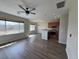 Bright and open living area with hardwood floors, a modern ceiling fan, and large windows showcasing the neighborhood at 13013 Grant Cir # C, Thornton, CO 80241