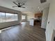 Bright living area with wood floors, a ceiling fan, recessed lighting, and an open floor plan to the kitchen at 13013 Grant Cir # C, Thornton, CO 80241