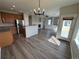 Open-concept living room with hardwood floors, stainless steel appliances, and ample natural light at 13013 Grant Cir # C, Thornton, CO 80241