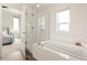 Bathroom with soaking tub and glass enclosed shower at 5668 Galena St, Denver, CO 80238
