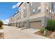 A row of townhome garages with neutral tones, matching doors, and clean concrete driveway at 5668 Galena St, Denver, CO 80238