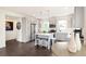 A modern kitchen design featuring stainless steel appliances, an island with barstools and light grey cabinetry at 5668 Galena St, Denver, CO 80238