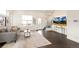 A cozy living room featuring a comfortable couch, modern decor, and dark wood floors with a stylish area rug at 5668 Galena St, Denver, CO 80238
