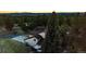 Aerial view of house with backyard deck and forest during sunset at 11437 Tomichi Dr, Franktown, CO 80116
