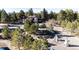 Aerial view of property nestled in large forest with fenced in playground at 11437 Tomichi Dr, Franktown, CO 80116