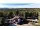 Aerial view of house in a forest with hot tub in the backyard at 11437 Tomichi Dr, Franktown, CO 80116