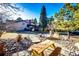 Well-manicured backyard with stone path, picnic table, and deck at 11437 Tomichi Dr, Franktown, CO 80116