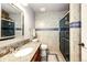 Stylish bathroom with tiled walls, a glass-enclosed shower, and granite countertops at 11437 Tomichi Dr, Franktown, CO 80116