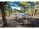A charming chicken coop sits beneath the trees in a large, wooded backyard at 11437 Tomichi Dr, Franktown, CO 80116