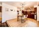 Cozy dining room with hardwood floors and direct access to the adjacent kitchen, perfect for entertaining at 11437 Tomichi Dr, Franktown, CO 80116
