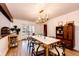 Dining room with stylish chandelier, wood floors, and glass doors opening to an outdoor patio at 11437 Tomichi Dr, Franktown, CO 80116