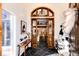 Grand foyer with striking black tile floors, a statement light fixture, and an open view of the home's interior at 11437 Tomichi Dr, Franktown, CO 80116
