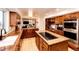 Expansive kitchen featuring granite countertops, premium appliances, and rich wood cabinetry, perfect for cooking at 11437 Tomichi Dr, Franktown, CO 80116