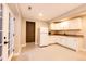 Basement kitchenette with white cabinets, a refrigerator, and an exterior entrance at 11437 Tomichi Dr, Franktown, CO 80116