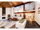 Bright living room with a modern fireplace, a balcony, and views into the adjacent dining area at 11437 Tomichi Dr, Franktown, CO 80116