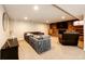 Cozy finished basement with brick fireplace, tv, and comfortable sectional seating at 11437 Tomichi Dr, Franktown, CO 80116