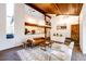 Open-concept living room with hardwood floors, natural light, and a fireplace, with views to the second floor at 11437 Tomichi Dr, Franktown, CO 80116