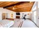 Bright main bedroom with a wood ceiling, private balcony, and exercise equipment at 11437 Tomichi Dr, Franktown, CO 80116