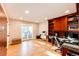 Bright home office with built-in shelving, a desk area, and sliding doors to a balcony at 11437 Tomichi Dr, Franktown, CO 80116