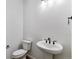 Cozy powder room with a pedestal sink and updated fixtures at 25284 E Warren Pl, Aurora, CO 80018
