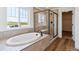 Luxury bathroom featuring soaking tub, modern shower and tile at 25284 E Warren Pl, Aurora, CO 80018