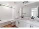Bright bathroom with double sink vanity, and modern fixtures at 25284 E Warren Pl, Aurora, CO 80018