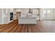 Bright kitchen features white cabinets, stainless steel appliances, and hardwood floors at 25284 E Warren Pl, Aurora, CO 80018