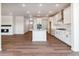 Open-concept living space with a modern kitchen, hardwood floors, and plenty of light at 25284 E Warren Pl, Aurora, CO 80018