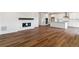 Open-concept living space with hardwood floors, a fireplace, and a modern kitchen at 25284 E Warren Pl, Aurora, CO 80018