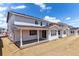 New home with a covered patio and sunroom addition offers outdoor living space at 25284 E Warren Pl, Aurora, CO 80018
