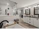 Spacious bathroom showcasing a double vanity, soaking tub with glass enclosure, and elegant gray and white finishes at 280 E 11Th Ave, Broomfield, CO 80020