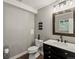 Modern bathroom features a dark vanity, a toilet, and a well-lit mirror at 280 E 11Th Ave, Broomfield, CO 80020