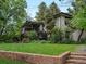Charming home exterior with a well-maintained lawn, stone retaining wall, and a covered deck at 280 E 11Th Ave, Broomfield, CO 80020