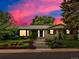 Charming home featuring a manicured lawn, white brick, blue door and lush greenery climbing on the walls at 280 E 11Th Ave, Broomfield, CO 80020