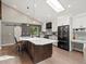 Bright, modern kitchen features a large island with seating, a skylight, and stainless steel appliances at 280 E 11Th Ave, Broomfield, CO 80020