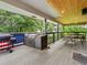 Covered deck featuring an outdoor kitchen with a built-in grill, dining area, and an American flag accent at 280 E 11Th Ave, Broomfield, CO 80020
