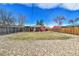 Large backyard with fencing and a combination of grass and rock landscaping at 6670 Hooker St, Denver, CO 80221