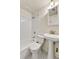 Classic bathroom features a pedestal sink, toilet and shower with white tile at 6670 Hooker St, Denver, CO 80221