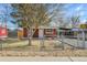 Charming single-story home featuring a fenced yard and mature tree at 6670 Hooker St, Denver, CO 80221