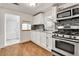 Modern kitchen with white cabinets, stainless steel appliances and backsplash at 6670 Hooker St, Denver, CO 80221