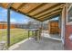 Covered patio with concrete flooring that overlooks the grassy fenced-in backyard at 6670 Hooker St, Denver, CO 80221