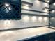 Stylish bar area with custom tile backsplash, floating shelves, wine storage, and sleek design at 9011 Sandpiper Dr, Longmont, CO 80504