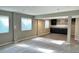 Open basement area with two windows and wet bar, perfect for entertaining at 9011 Sandpiper Dr, Longmont, CO 80504
