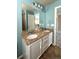 Bathroom featuring a tub with shower, tiled walls, and double sink vanity at 9011 Sandpiper Dr, Longmont, CO 80504