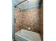 Bathroom featuring a tub with shower, tiled walls, and grab bars at 9011 Sandpiper Dr, Longmont, CO 80504